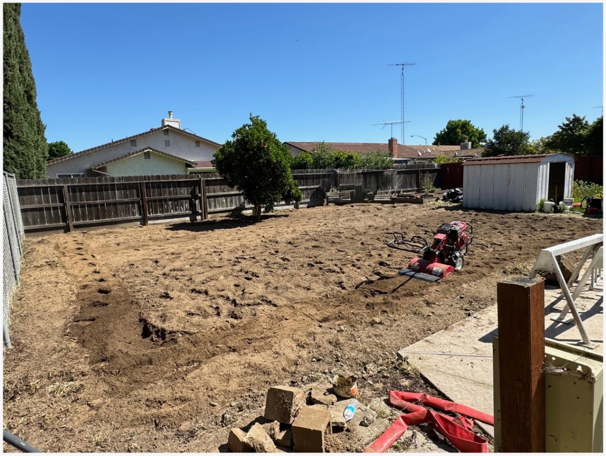 Backyard artificial turf installation — before